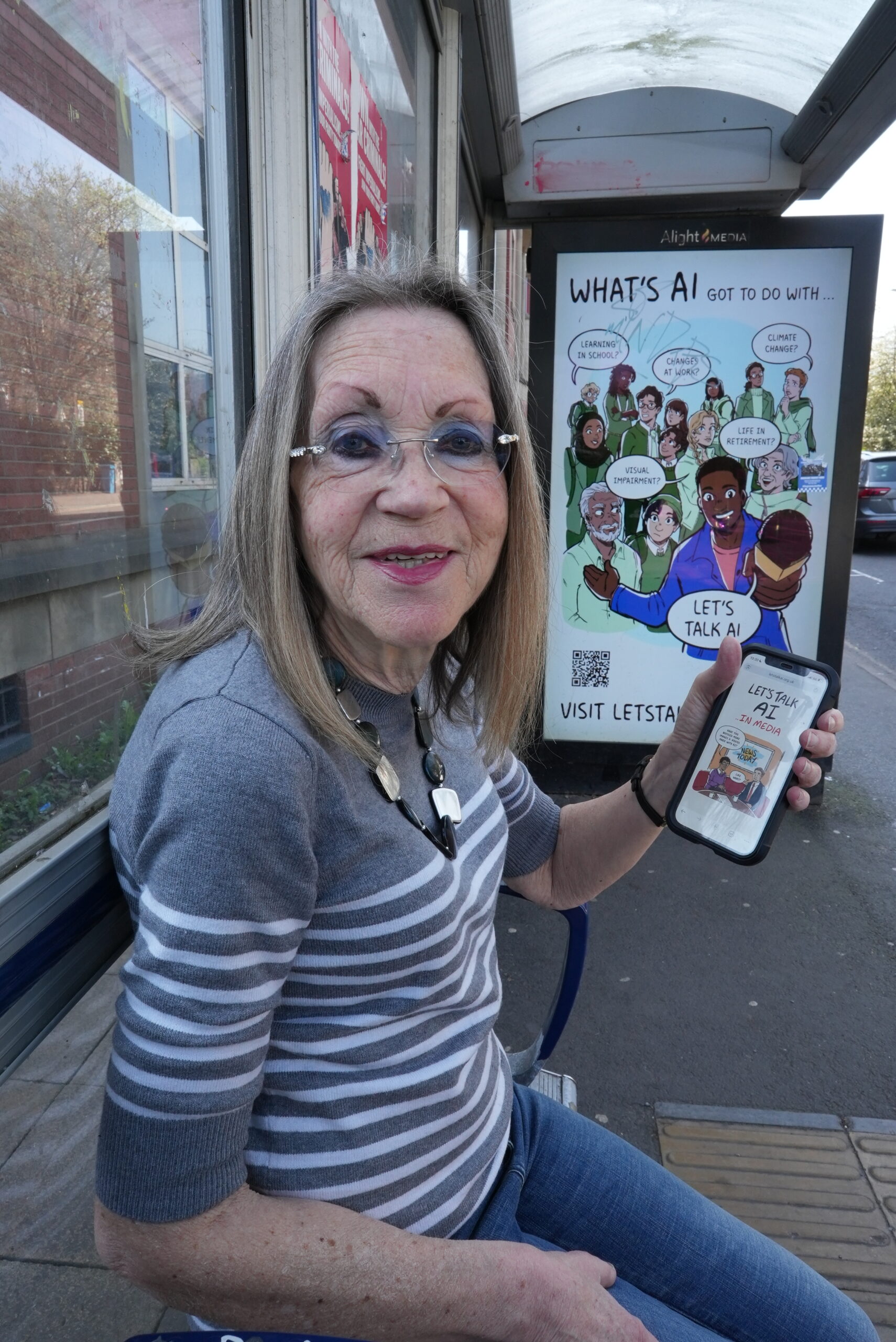 Woman in glasses sitting at bus stop advertising Lets Talk AI